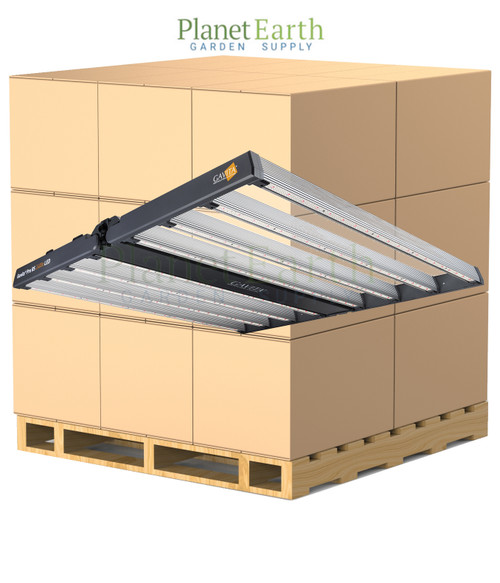 Gavita Pro RS 2400e LED grow light hovering in front of a pallet stacked with cardboard boxes.