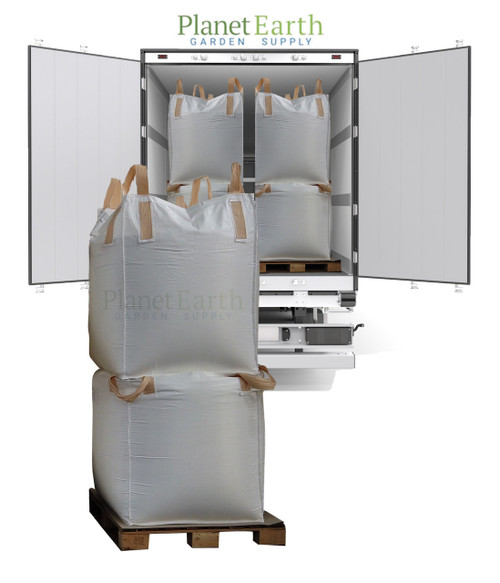 Two large white bulk totes on a wooden pallet, with more visible inside an open delivery truck.