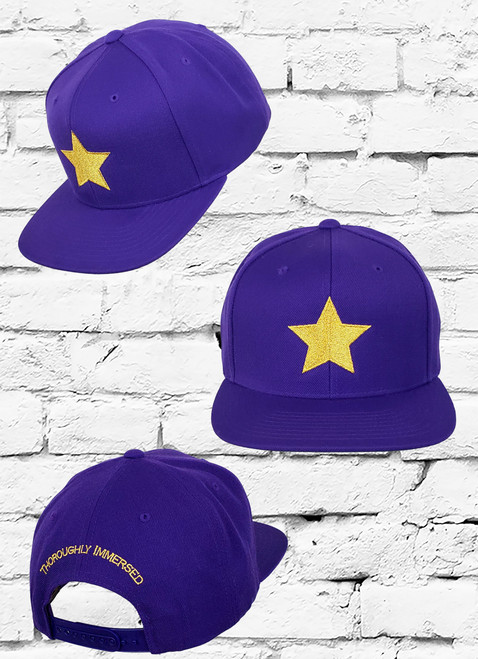 The Omega Psi Phi Snapback features an allover poly-blend fabrication an embroidered metallic gold star logo at the front panels and the words "Omega Psi Phi" at the rear.