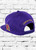 Rear view of ΩΨΦ 1911 Sideline Snapback featuring an embroidered Omega Psi Phi founded year at the front with an embroidered  Omega symbol on  the left-wear side and Omega Psi Phi embroidered at the rear above an adjustable snapback closure. 
