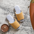 Yellow wide-band open-toe house slippers overhead view