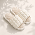 Textured linen upper detail on an open-toe slipper