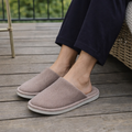 Woman wearing brown pinstripe closed-toe house slippers