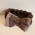 Brown textured plush bow spa headband on a neutral surface