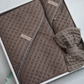 Brown three-piece waffle towel spa set arranged in an open gift box