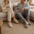 Couple wearing beige and gray closed-toe house slippers at home