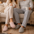 Couple wearing pink and gray closed-toe house slippers at home