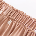 Wide elastic waistband on taupe polka dot pajama pants