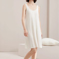 Woman wearing beige Essential modal sleeveless lounge dress in a soft neutral setting