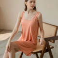 Woman wearing orange Essential modal sleeveless lounge dress with built-in bra