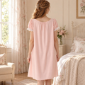 Pink cotton lounge dress back view in a soft home setting