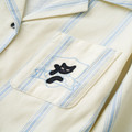 Close-up of black cat embroidery on the striped cotton chest pocket
