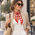 Woman wearing red diamond-print satin twilly scarf tied at the neck