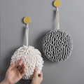 White and gray round hand towels displayed on wall hooks