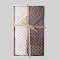 Brown and beige waffle-weave towel set in an open gift box