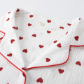 Close-up of cotton gauze heart print pajama collar and red piping