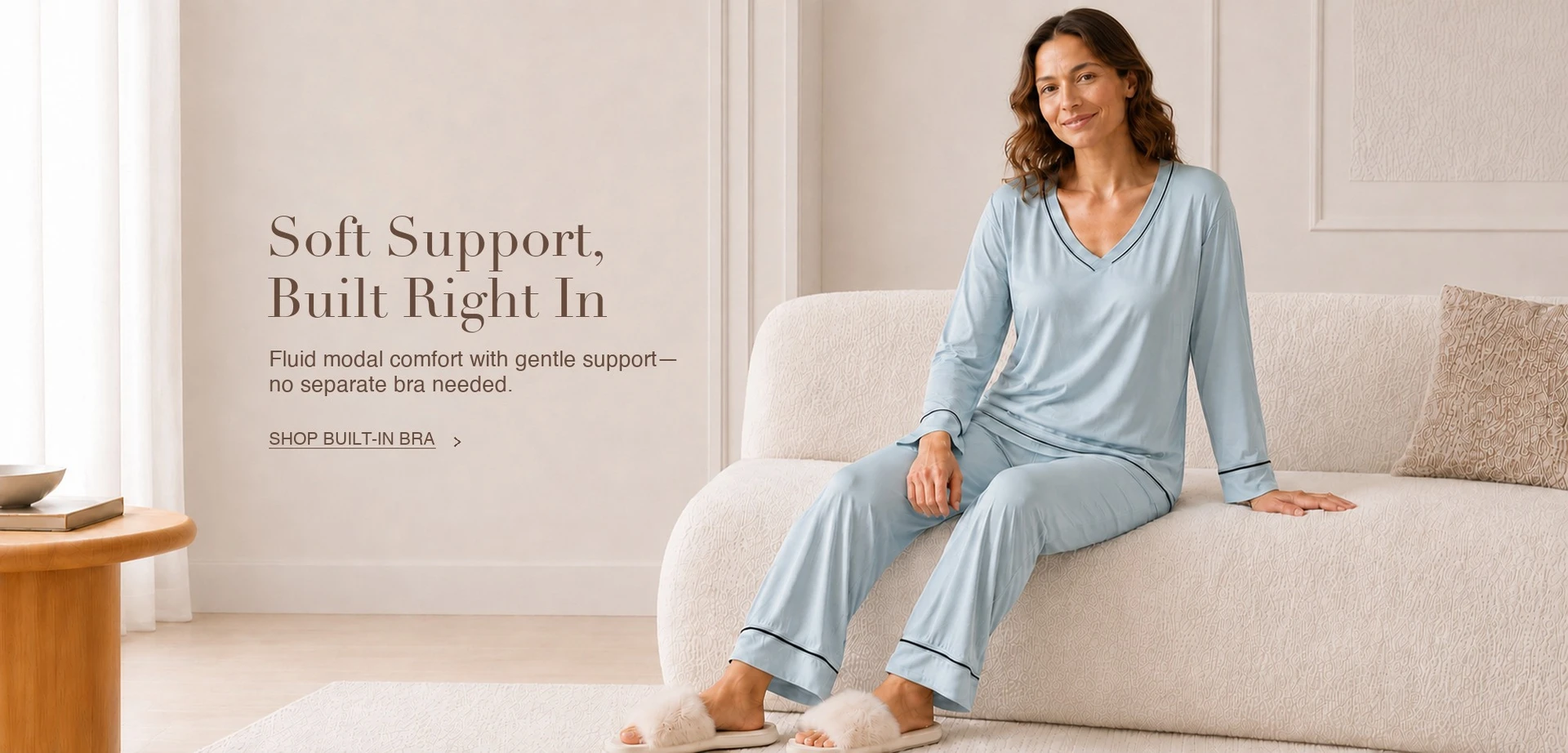 Woman wearing a pale blue DrifWoo built-in bra modal lounge set in a calm living room
