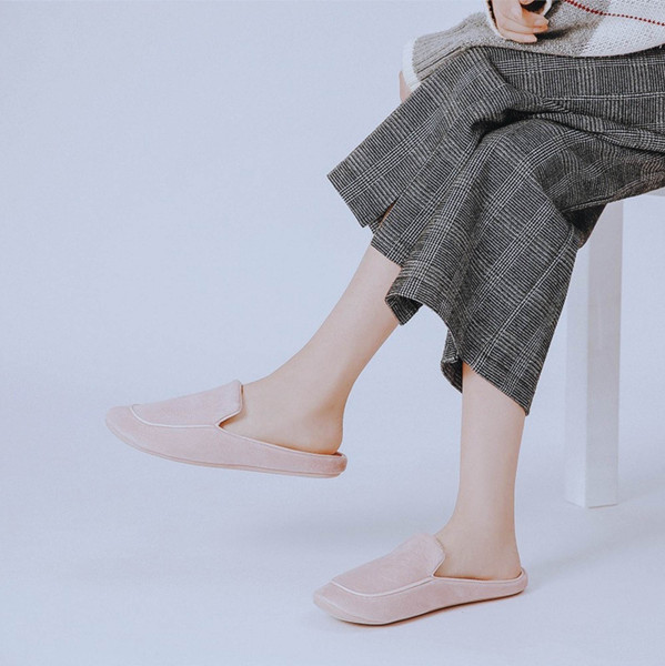 Side view of pink closed-toe house slippers worn indoors