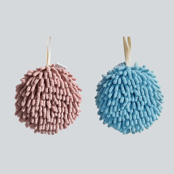 Pink and blue round hanging hand towels on a plain background