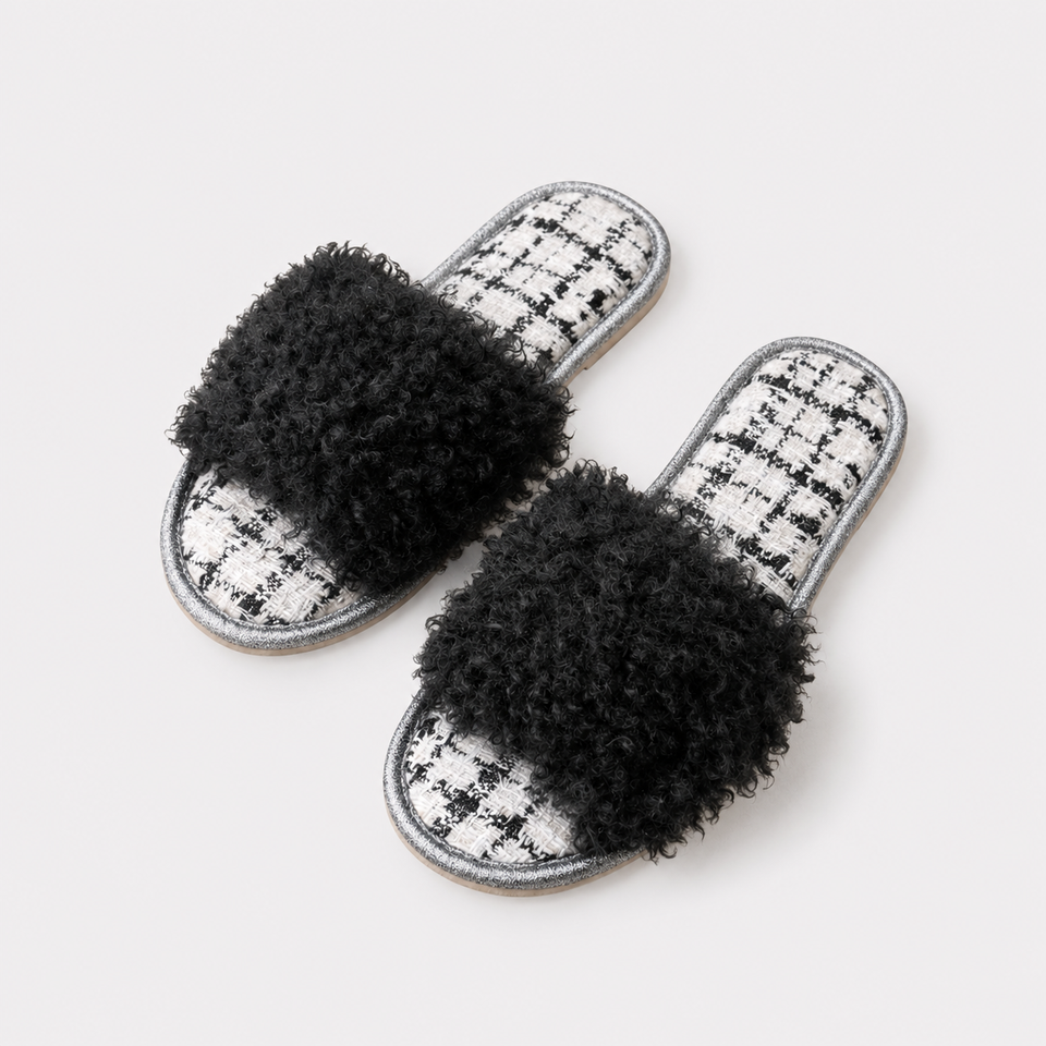 Women’s black curly plush open-toe house slippers on a light background