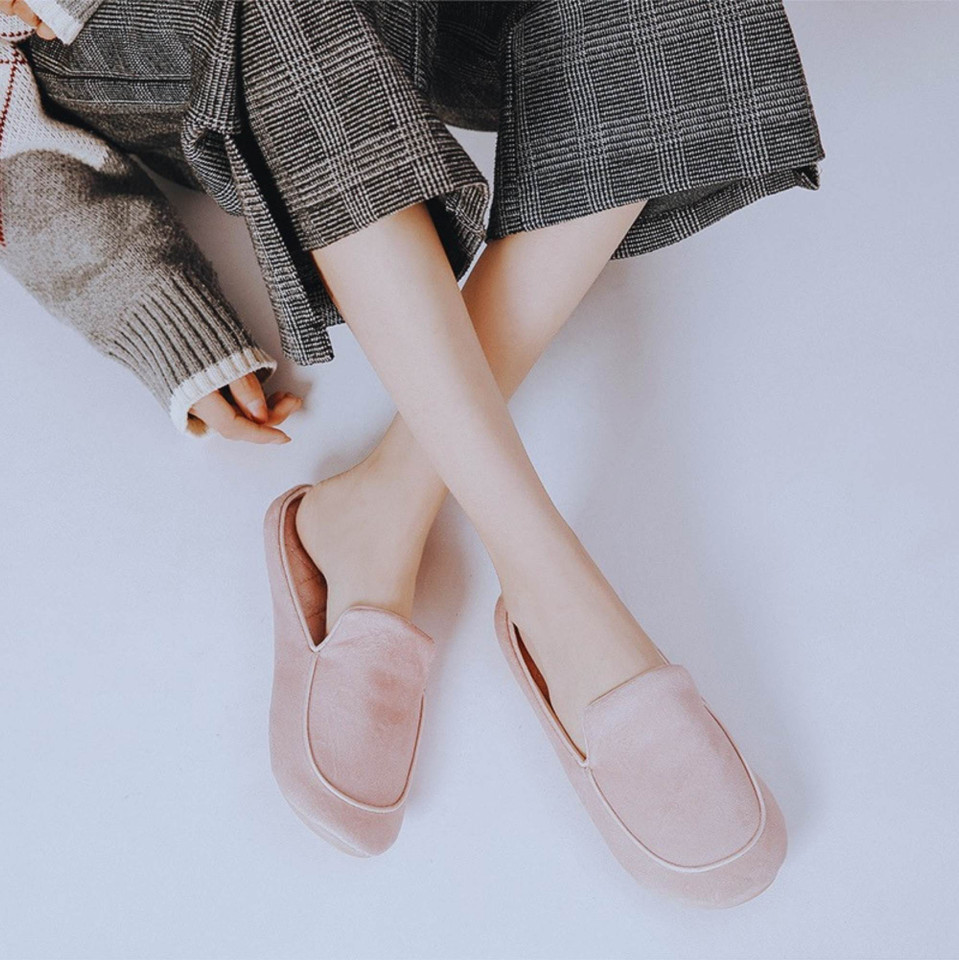 Pink closed-toe house slippers worn indoors