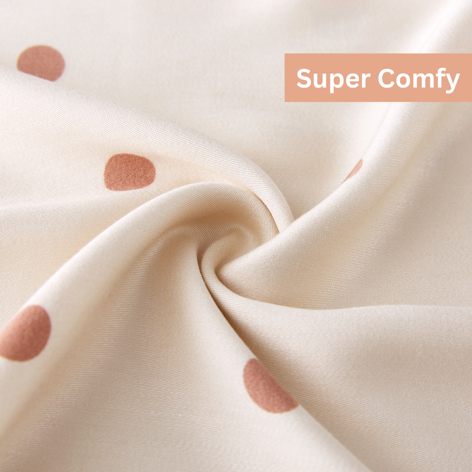 Soft ivory polka dot viscose fabric close up