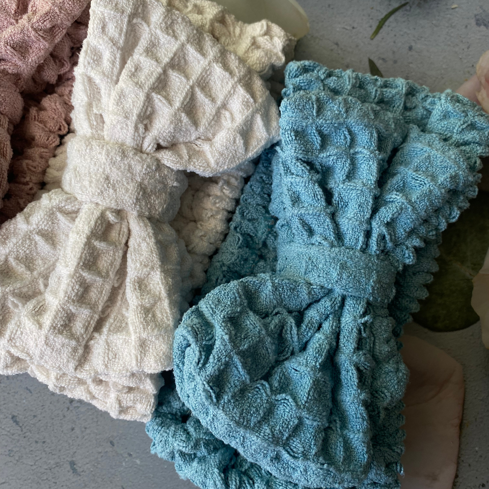 Beige and blue waffle-texture bow spa headbands, close-up
