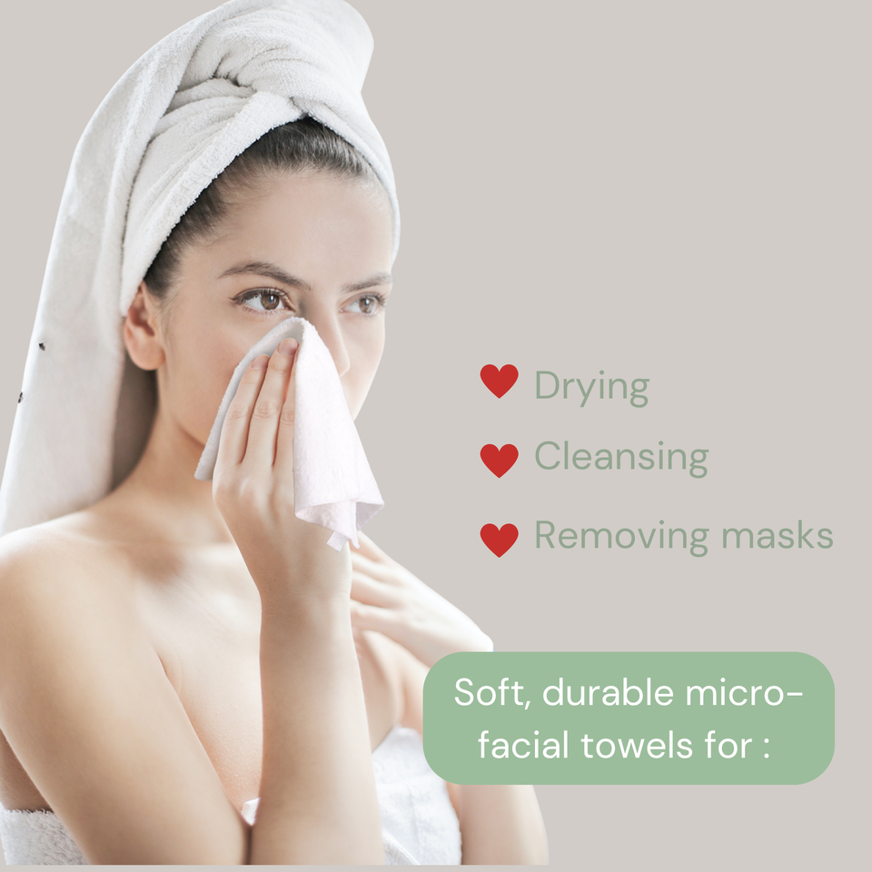 Woman holding a white face towel to her cheek