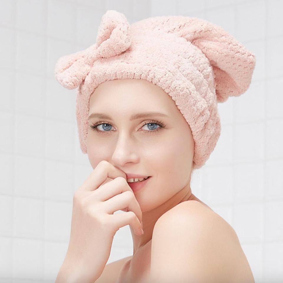 Woman wearing the mauve pink bow hair towel