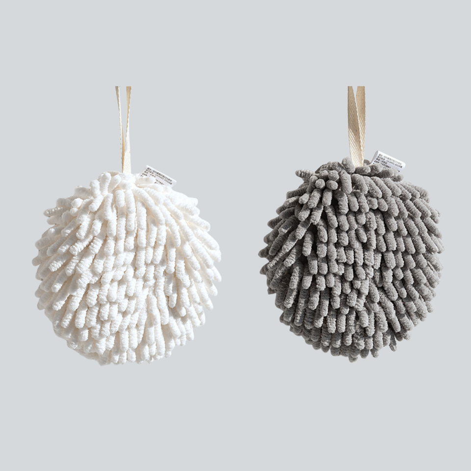 White and gray round hanging hand towels on a plain background