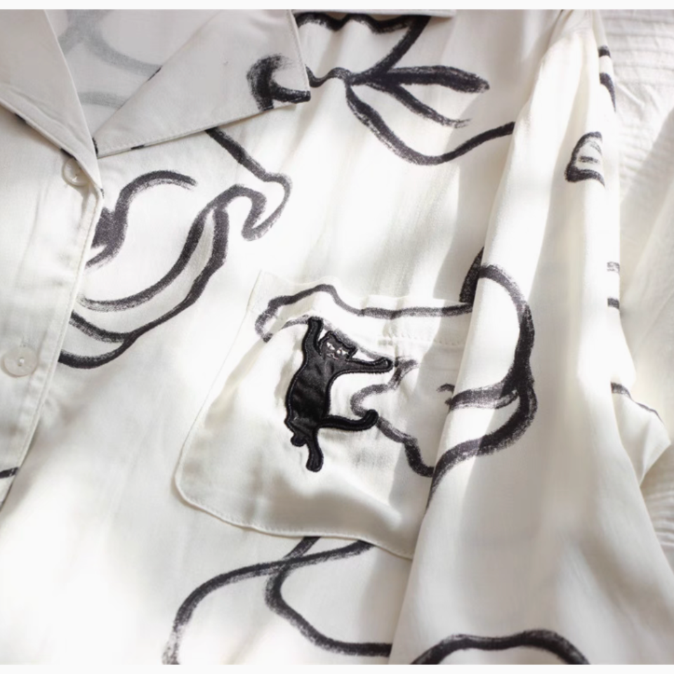 Relaxed wide leg pajama pants with elastic waist and black ink motif