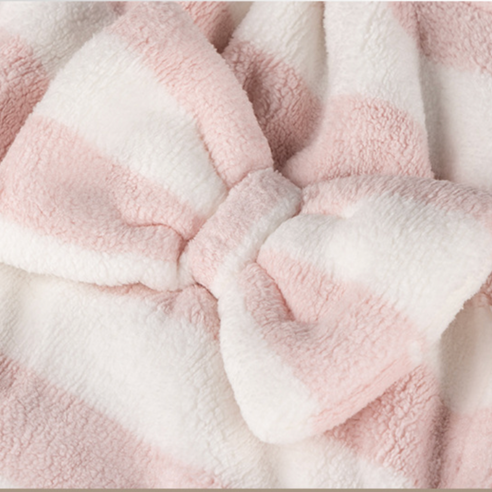 Close-up of the bow detail on the pink striped spa towel wrap