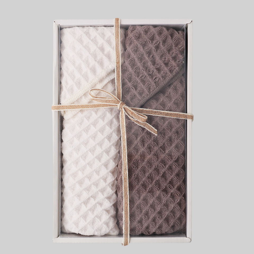 Brown and beige waffle-weave towel set in an open gift box