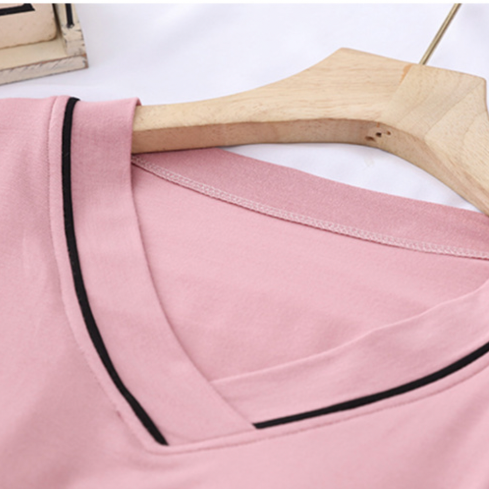 Close-up of pink V-neckline with contrast piping and inner shelf construction