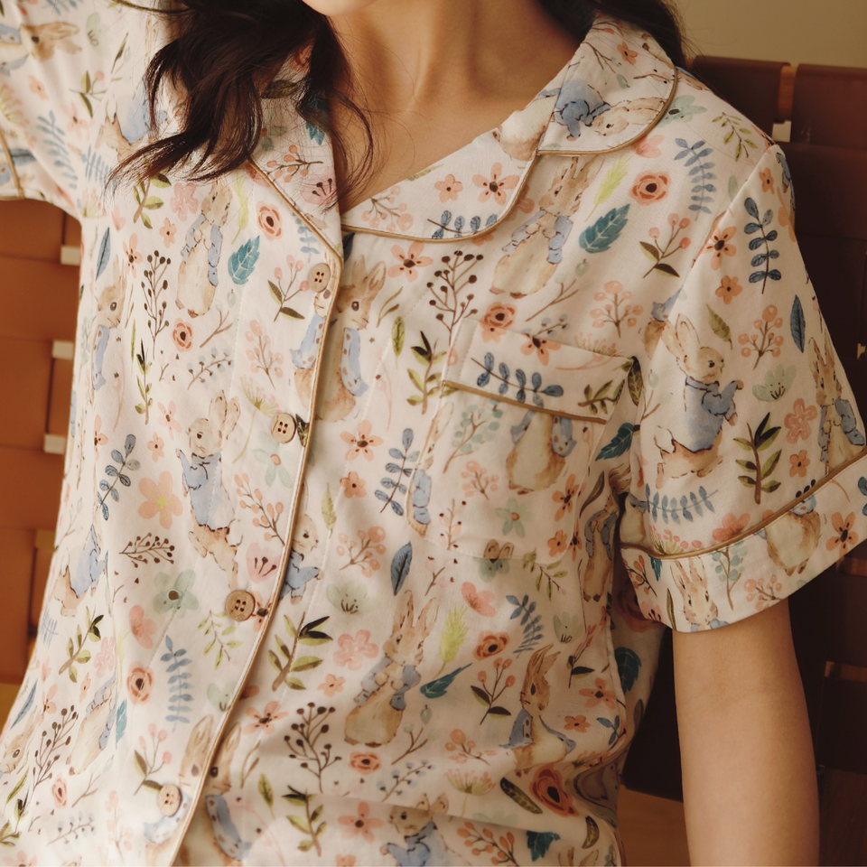 Close-up of the Meadow Calm button-front top, pocket, and botanical print
