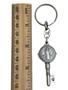 Close-up of a Saint Benedict keychain, showcasing the intricate details of the medal with its cross and inscriptions.