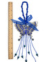A silver butterfly wall hanging adorned with blue evil eye beads, featuring a larger blue stone in the center and blue tassel accents.