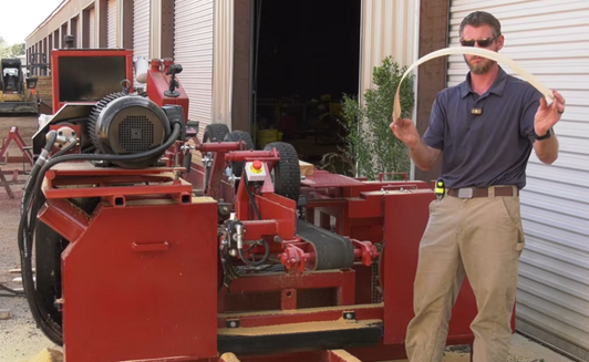 Operator using PR6 pallet resaw with dual cutting heads, high output pallet bandsaw machine increasing yield and reducing waste in lumber processing facility