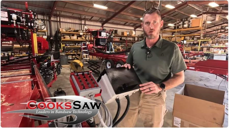 Robert introduces Cook’s Saw Computer Setworks beside the sawmill controls in the shop.