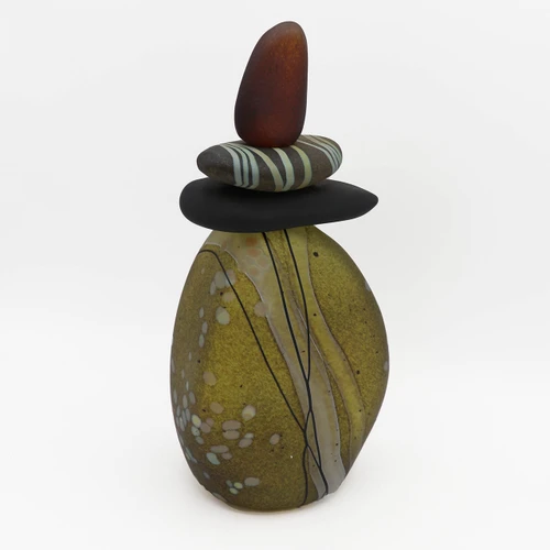 Blown glass cairn sculpture by Melanie Leppla with three glass stones stacked on top of an olive green base