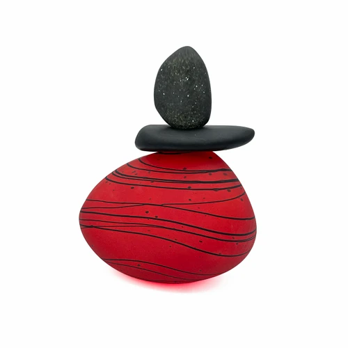 Back view of blown glass cairn sculpture by Melanie Leppla with two glass stones stacked on top of a red base