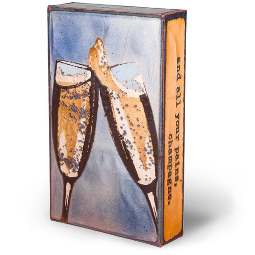 small wall or desk art with champagne glasses clanking.  Right side view.