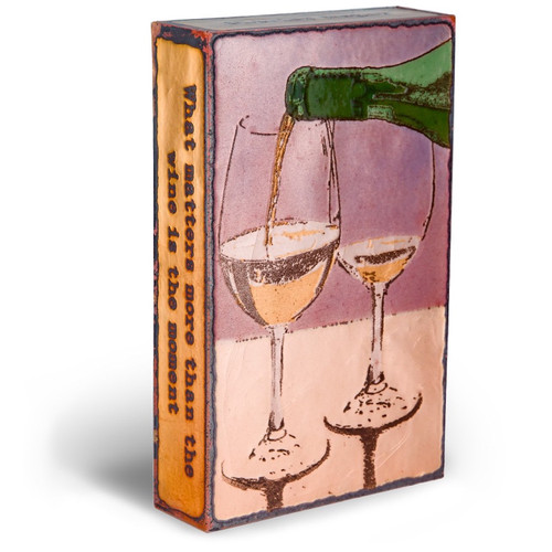 small wall or desk art with a bottle of white wine pouring into two wine glasses.  Left side view. small wall or desk art with a bottle of white wine pouring into two wine glasses.  Left side view.