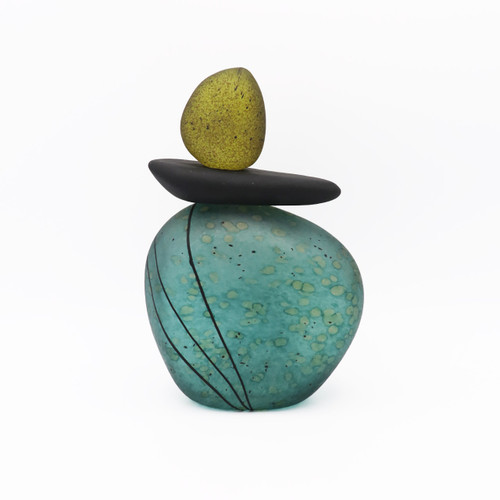 Angled view of blown glass cairn sculpture by Melanie Leppla with two glass stones stacked on top of a teal base