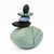 Blown glass cairn sculpture by Melanie Leppla with four glass stones stacked on top of a seafoam base