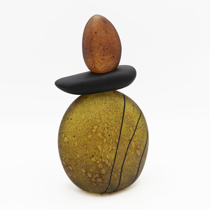 Blown glass cairn sculpture by Melanie Leppla with two glass stones stacked on top of a speckled olive base