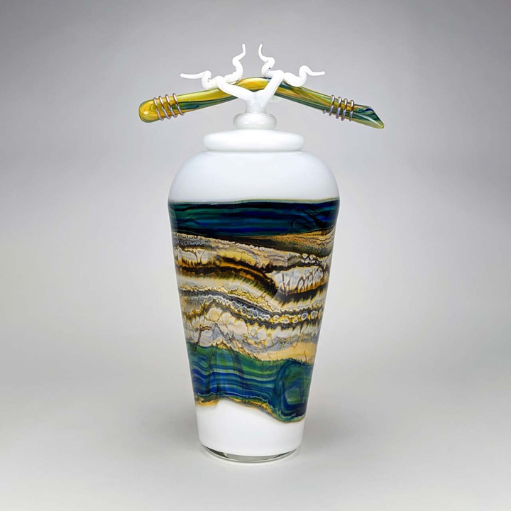 blue and white glass vase with covered top