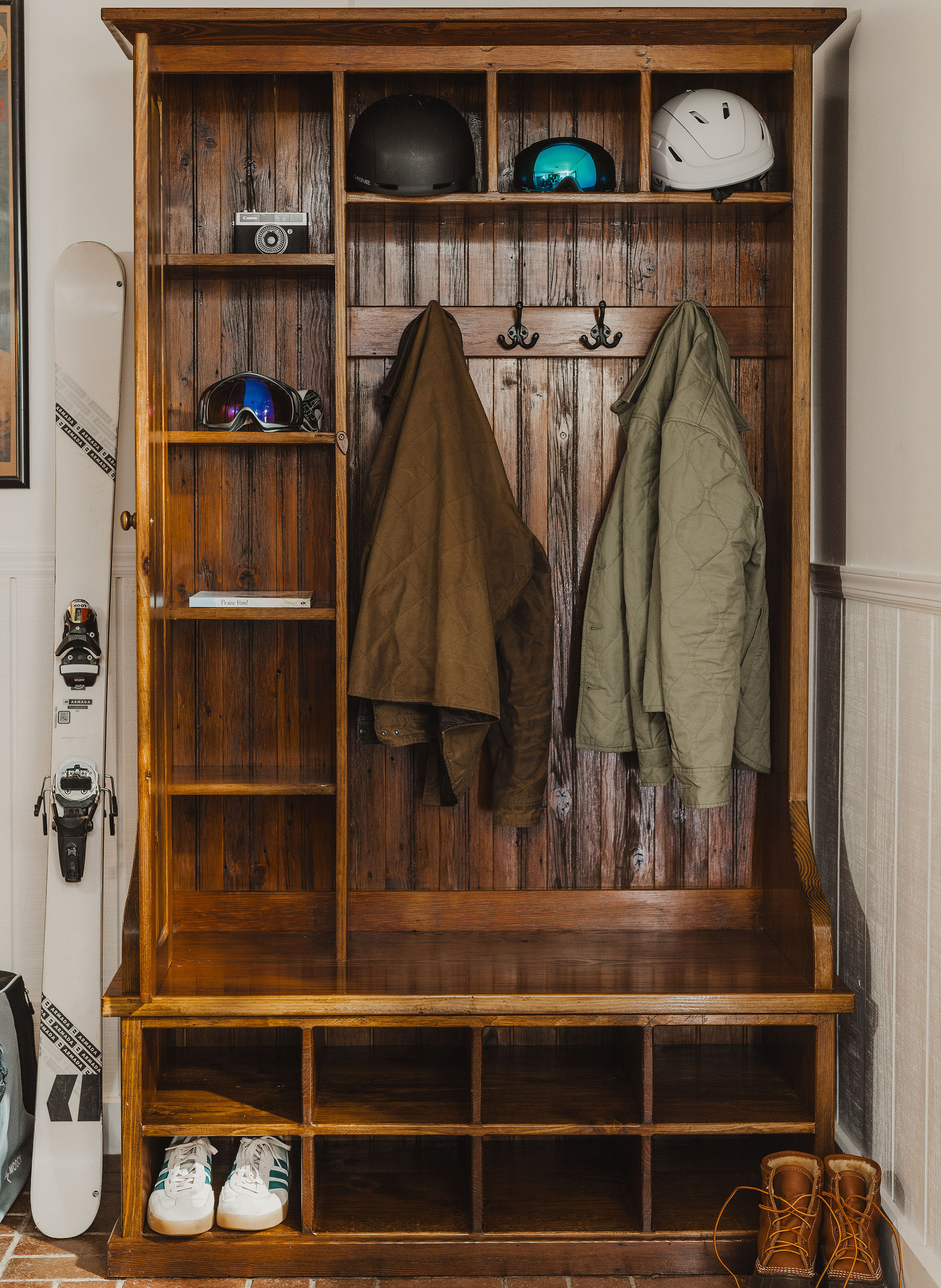 Reclaimed wood mudroom bench in a warm entryway