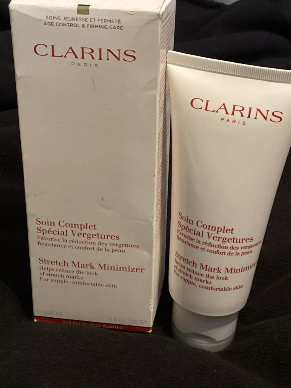 Clarins Stretch Mark Minimizer 6.8 oz (200 ml) in a white and red tube packaging.​
