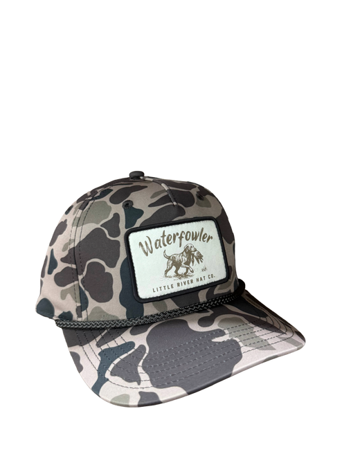 WaterFowler 258 trucker hat in Duck Marsh Camo with dog retrieving bird patch and rope detail